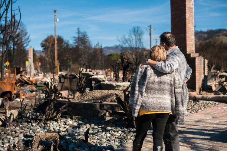Man and his wife owners, checking burned and ruined house